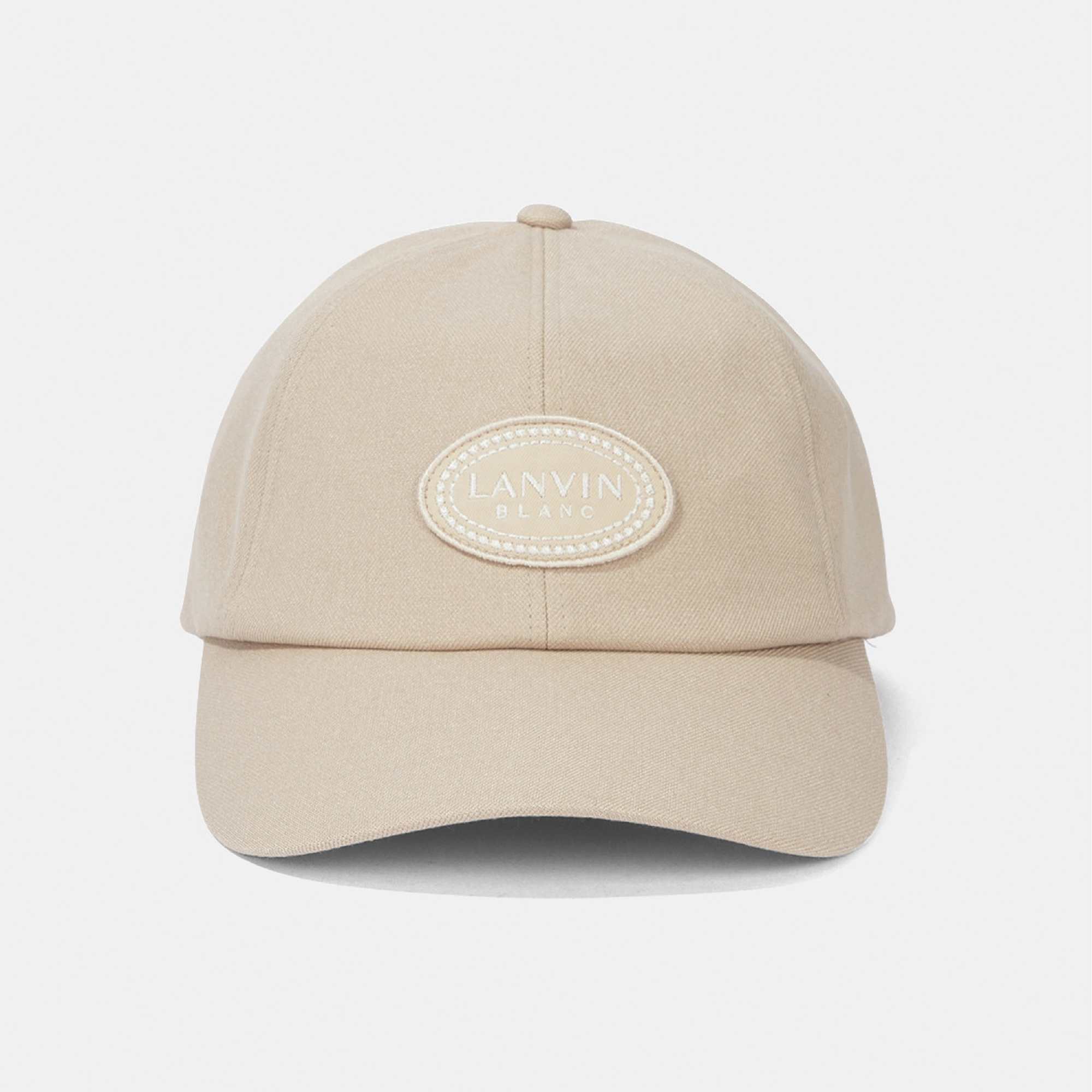 A beige baseball cap with an oval embroidered patch on the front reading 'LANVIN BLANC'.