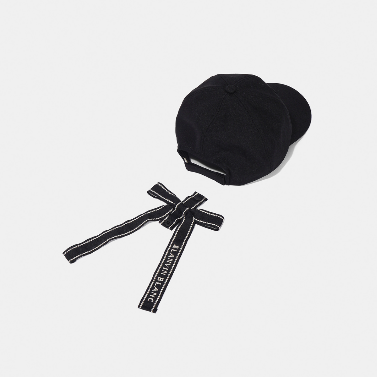 A black baseball cap with a matching black fabric chin strap featuring white contrast stitching and the brand name 'JUNNAEANG' printed in white, displayed on a light gray background.