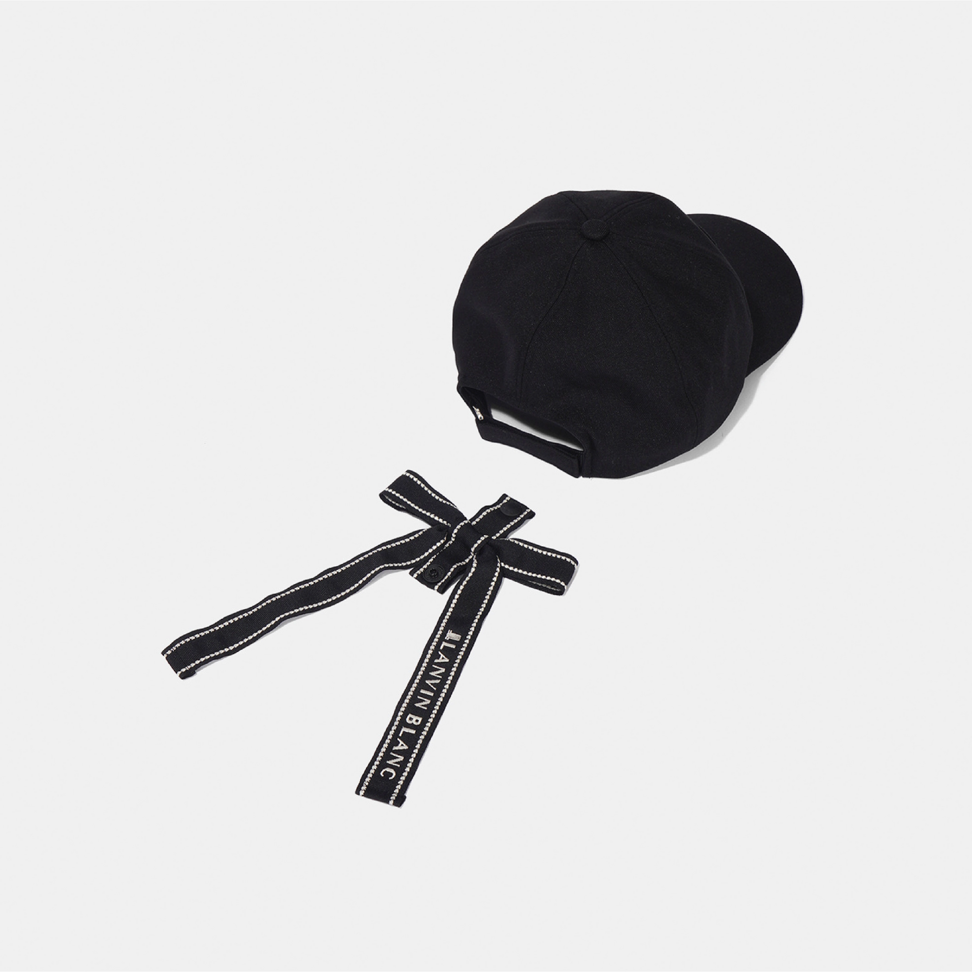 A black baseball cap with a matching black fabric chin strap featuring white contrast stitching and the brand name 'JUNNAEANG' printed in white, displayed on a light gray background.