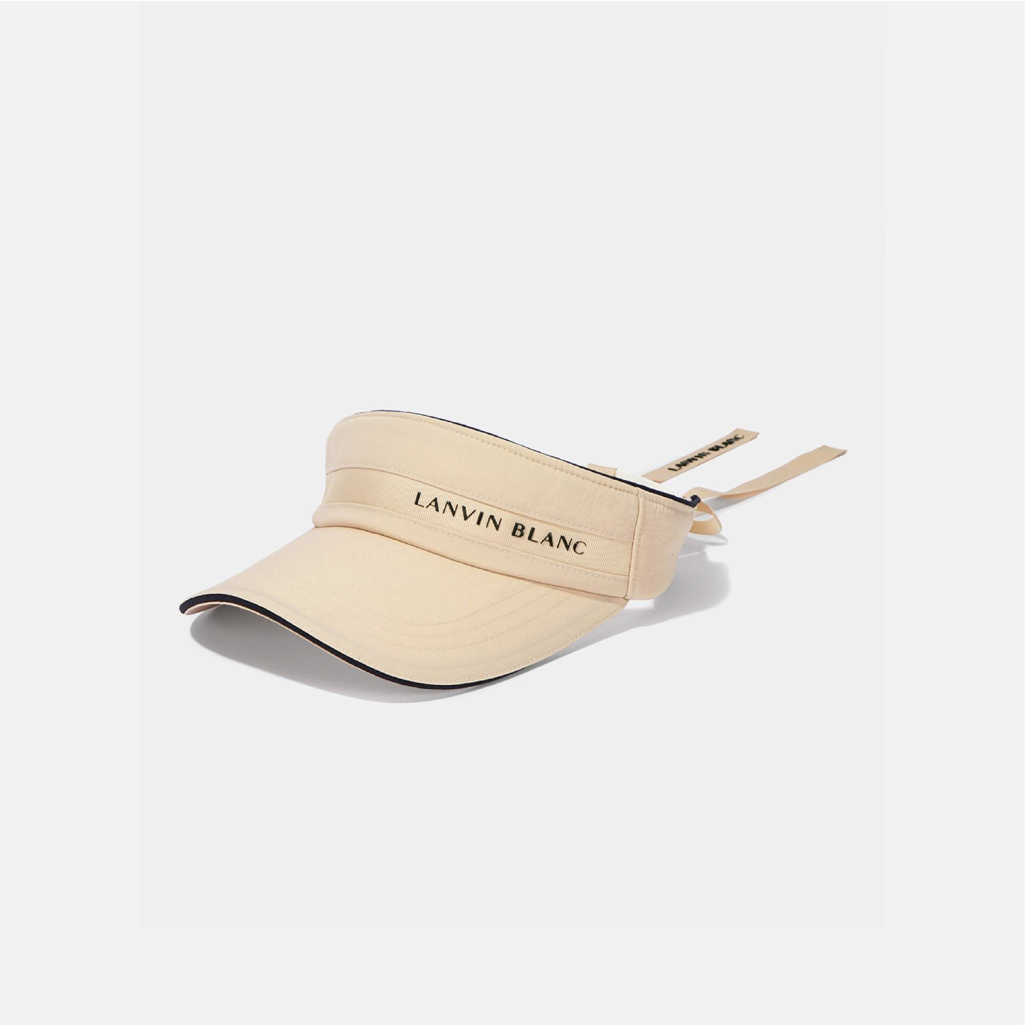 A beige visor hat with 'LANVIN BLANC' printed in black on the front band, shown on a light gray background.