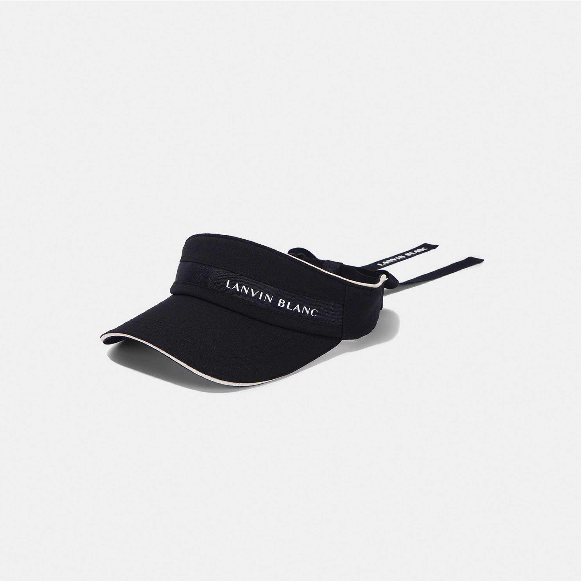 A black visor hat with white trim and the brand name 'LANVIN BLANC' printed in white on the front band, shown on a light gray background.