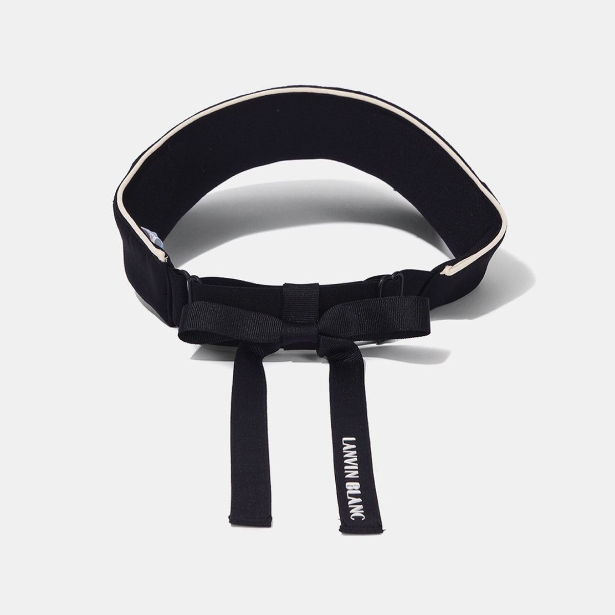 A black waist belt with a bow detail and adjustable buckle, featuring white piping along the top edge and white text reading 'LANVIN BLANC' on the hanging strap, set against a light gray background.