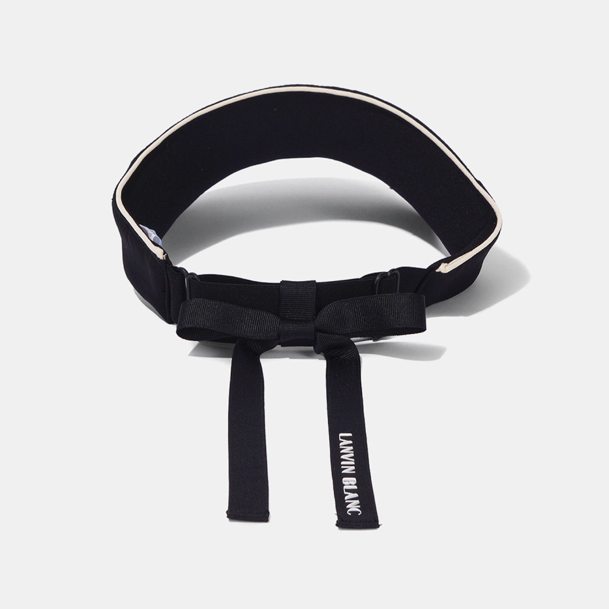 A black waist belt with a bow detail and adjustable buckle, featuring white piping along the top edge and white text reading 'LANVIN BLANC' on the hanging strap, set against a light gray background.