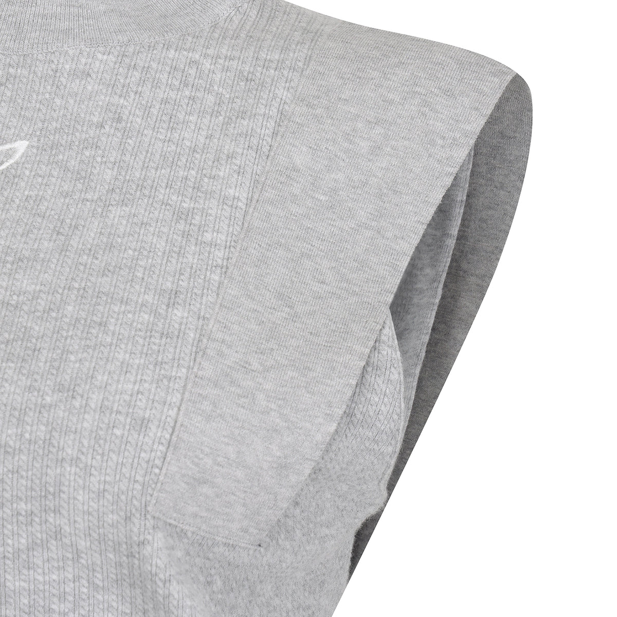 Close-up of a light gray sleeveless athletic top showing the ribbed knit fabric and folded sleeve edge against a white background.