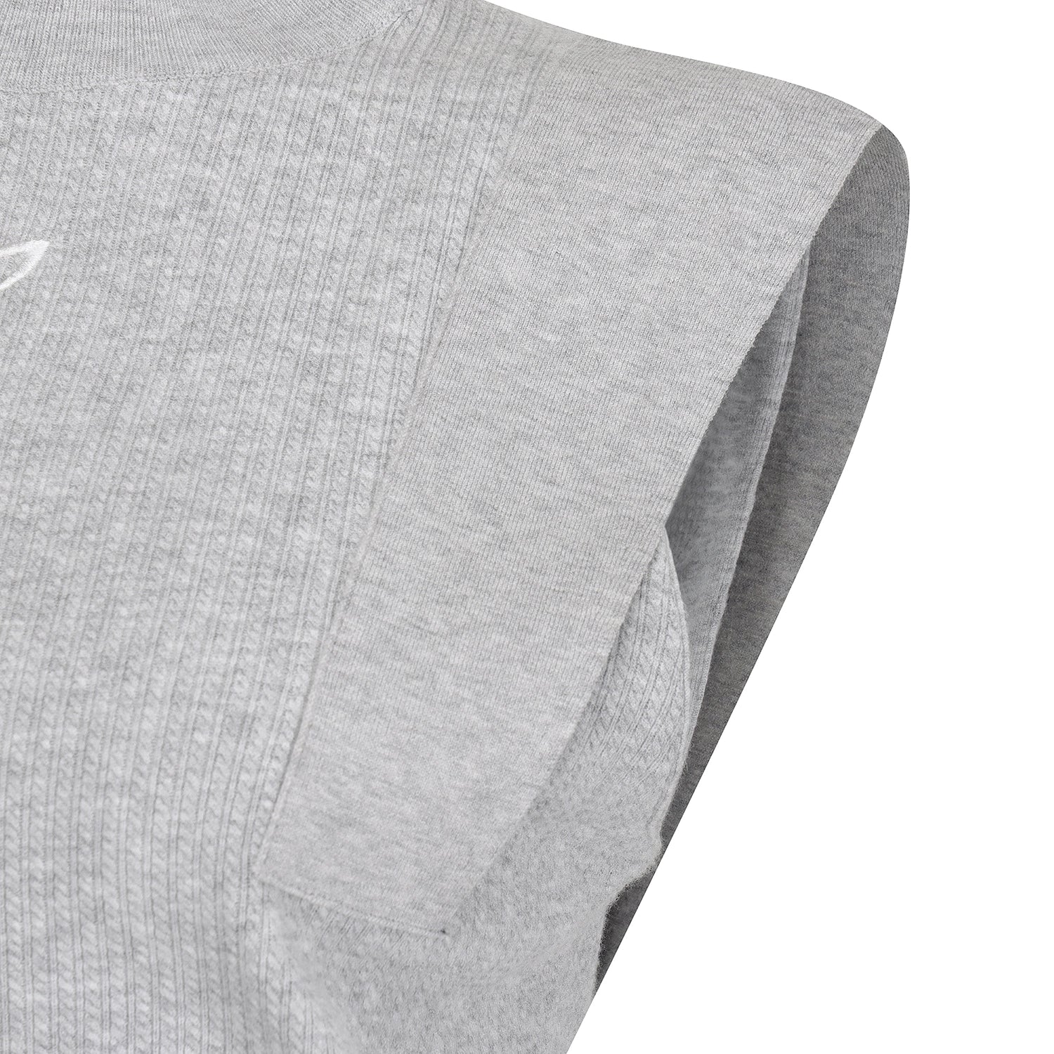 Close-up of a light gray sleeveless athletic top showing the ribbed knit fabric and folded sleeve edge against a white background.