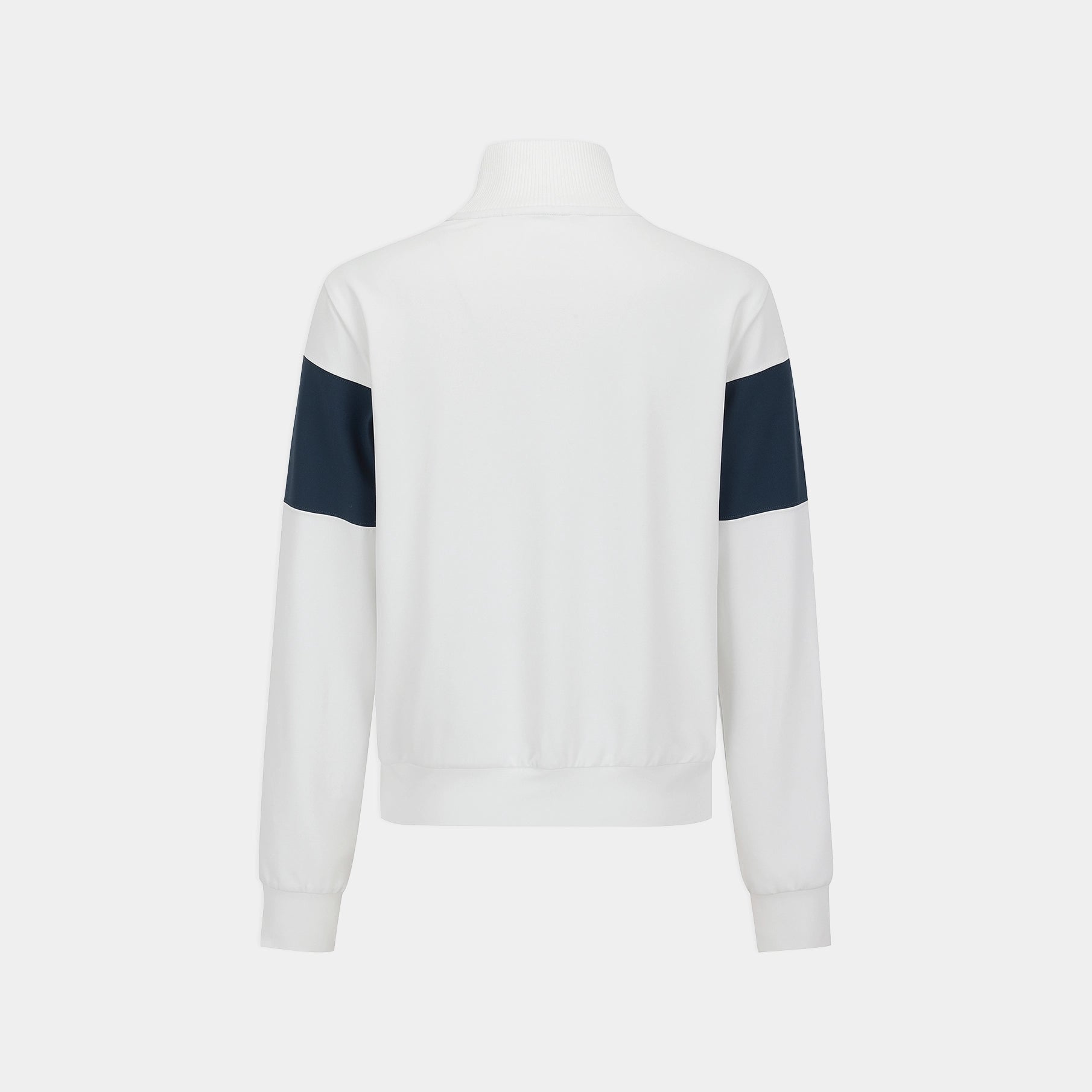 A white long-sleeve track jacket with contrasting dark navy blue color-blocked panels on the upper arms, shown from the back on a mannequin against a light gray background.