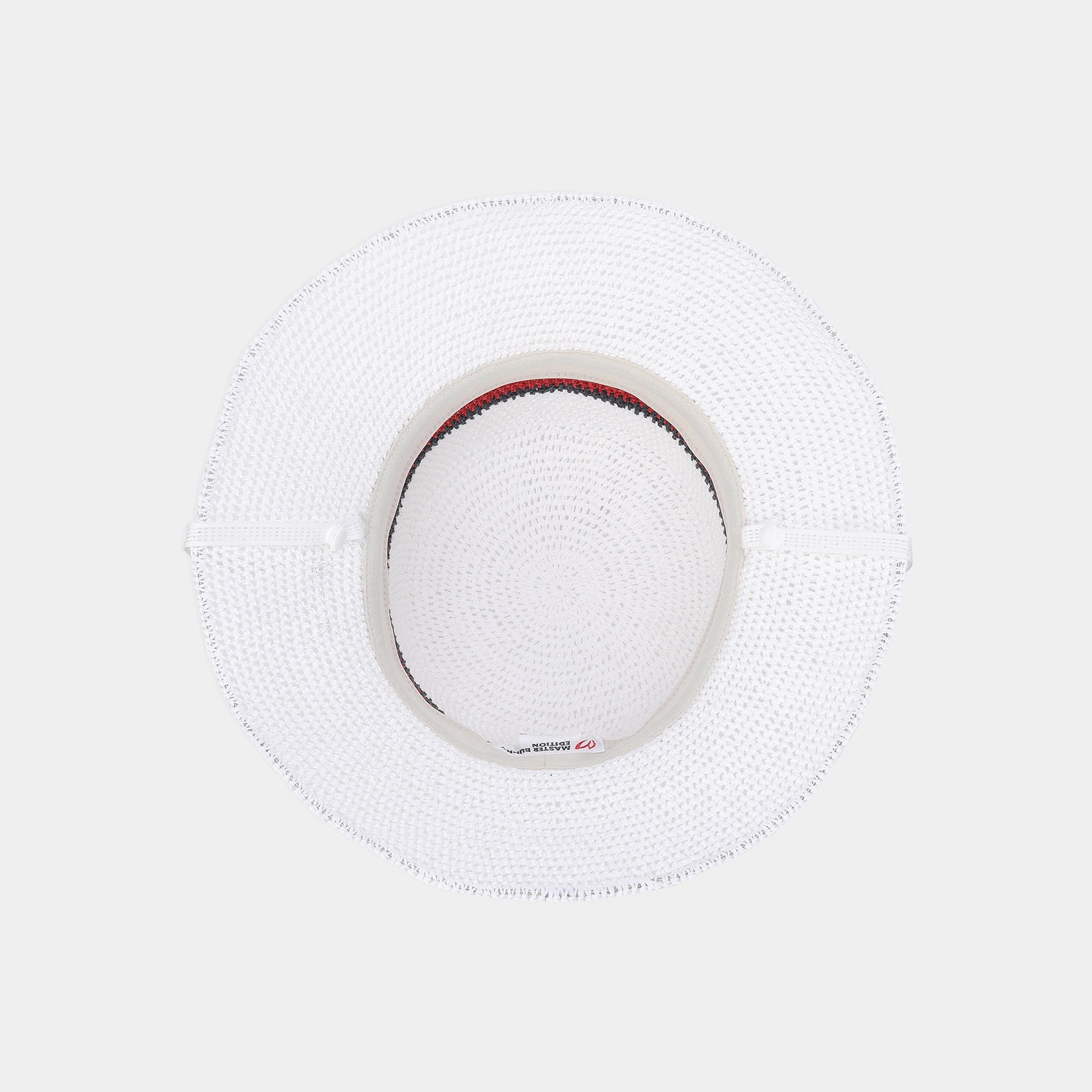 A white woven straw sun hat viewed from directly above, featuring a structured brim and a small red and blue striped detail on the inner crown.