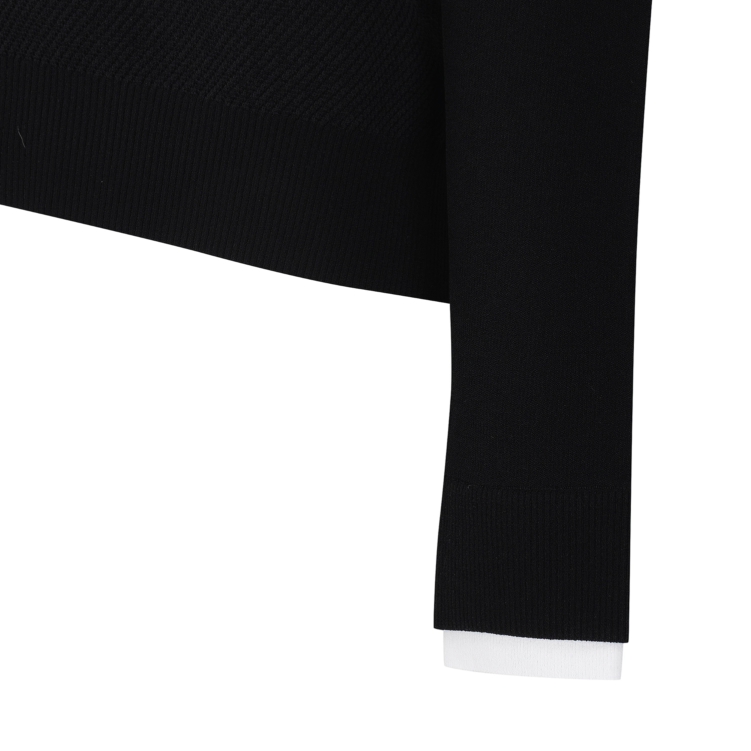 Close-up detail of a black ribbed knit garment, showing the sleeve cuff and hem against a plain white background.