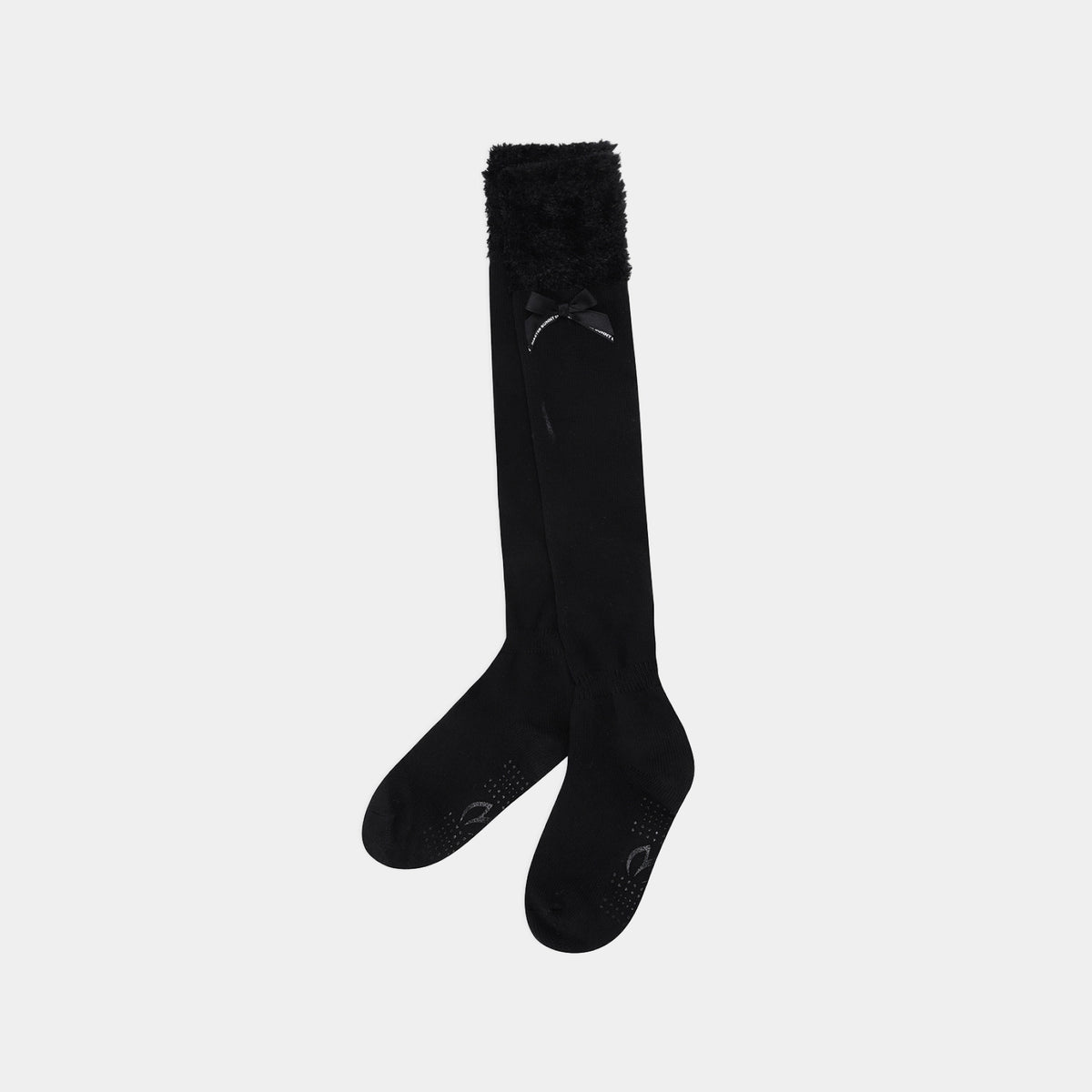 A pair of black over-the-knee socks with a fluffy black faux-fur trim at the top and textured grip dots on the toes, shown against a light gray background.