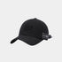 A black baseball cap with a curved brim, featuring a tonal embroidered leaf logo on the front and a small black-and-white brand patch on the side, set against a light gray background.