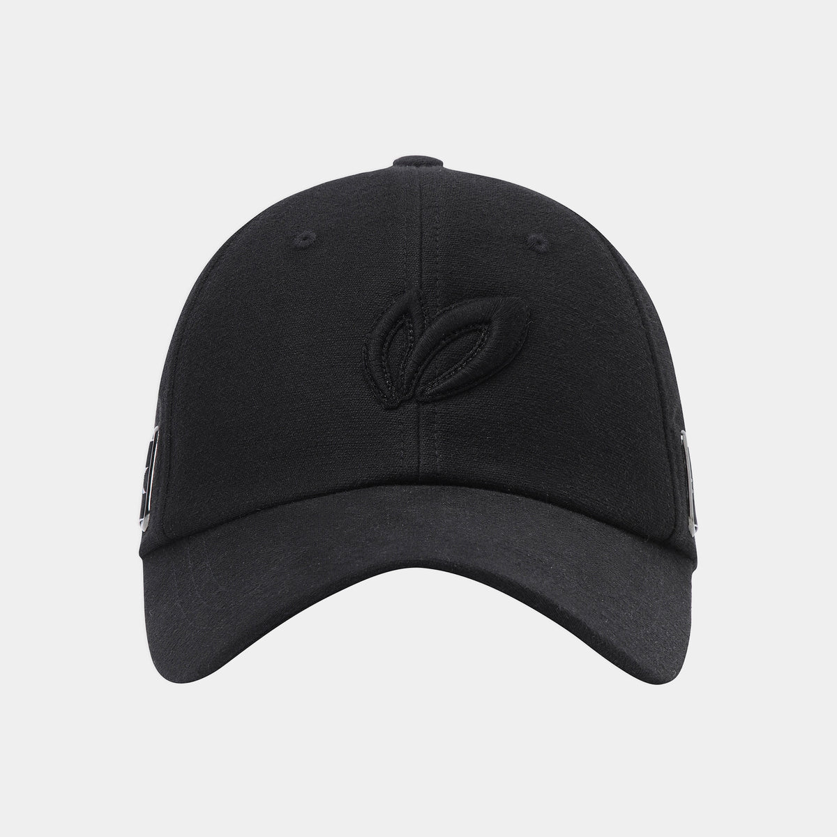 A black baseball cap with a tonal embroidered leaf logo on the front, shown against a light gray background.