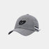 A gray plaid baseball cap with a black embroidered logo on the front and a black-and-white striped accent tab on the side, shown against a light gray background.