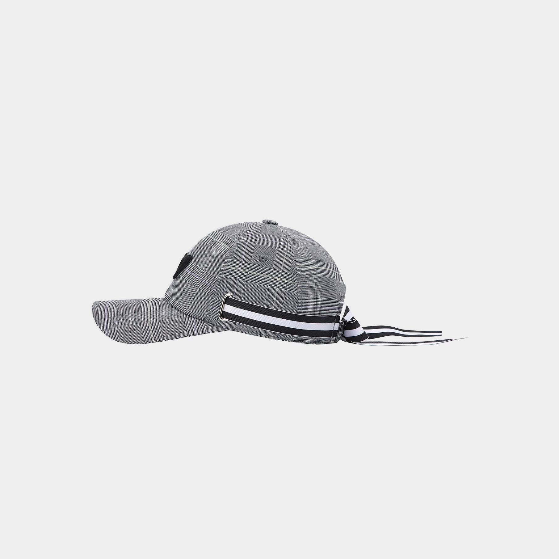 A gray plaid baseball cap with a black and white striped ribbon tied to the back of the crown, shown against a light gray background.