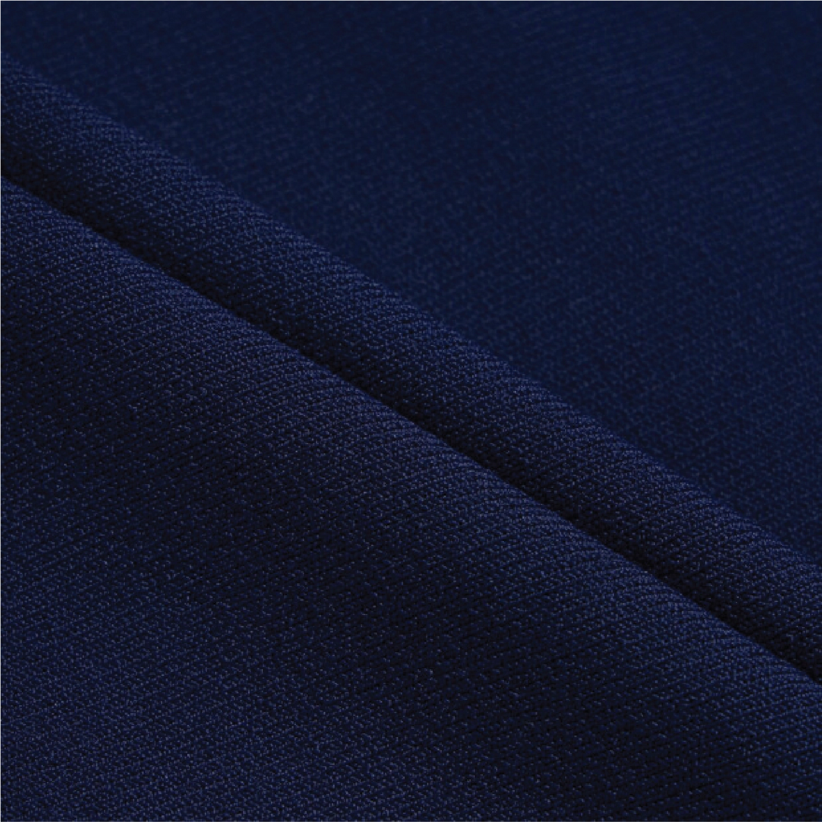 A close-up of dark navy blue knit fabric with a diagonal fold showing the texture and weave.