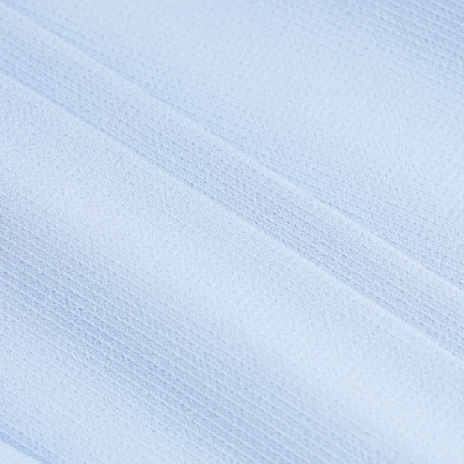A close-up of light blue textured fabric with a fine ribbed or waffle-like weave and soft diagonal folds.