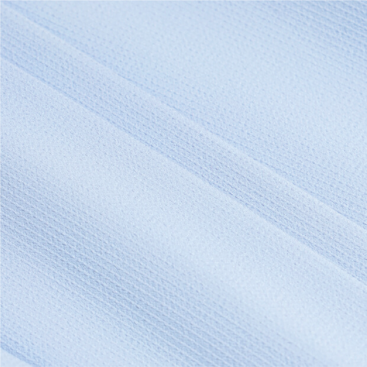 A close-up of light blue textured fabric with a fine ribbed or waffle-like weave and soft diagonal folds.