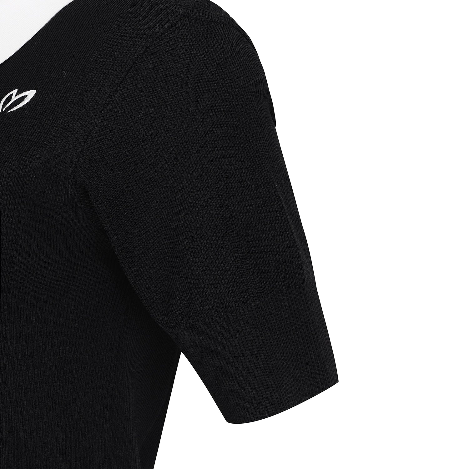 Close-up of a black ribbed short-sleeve top showing the shoulder, upper chest, and sleeve on a plain white background.