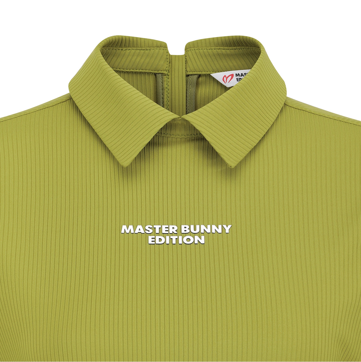 Close-up of a collared ribbed knit top in a muted olive-lime green, with white text reading 'MASTER BUNNY EDITION' across the chest and a small visible neck label.
