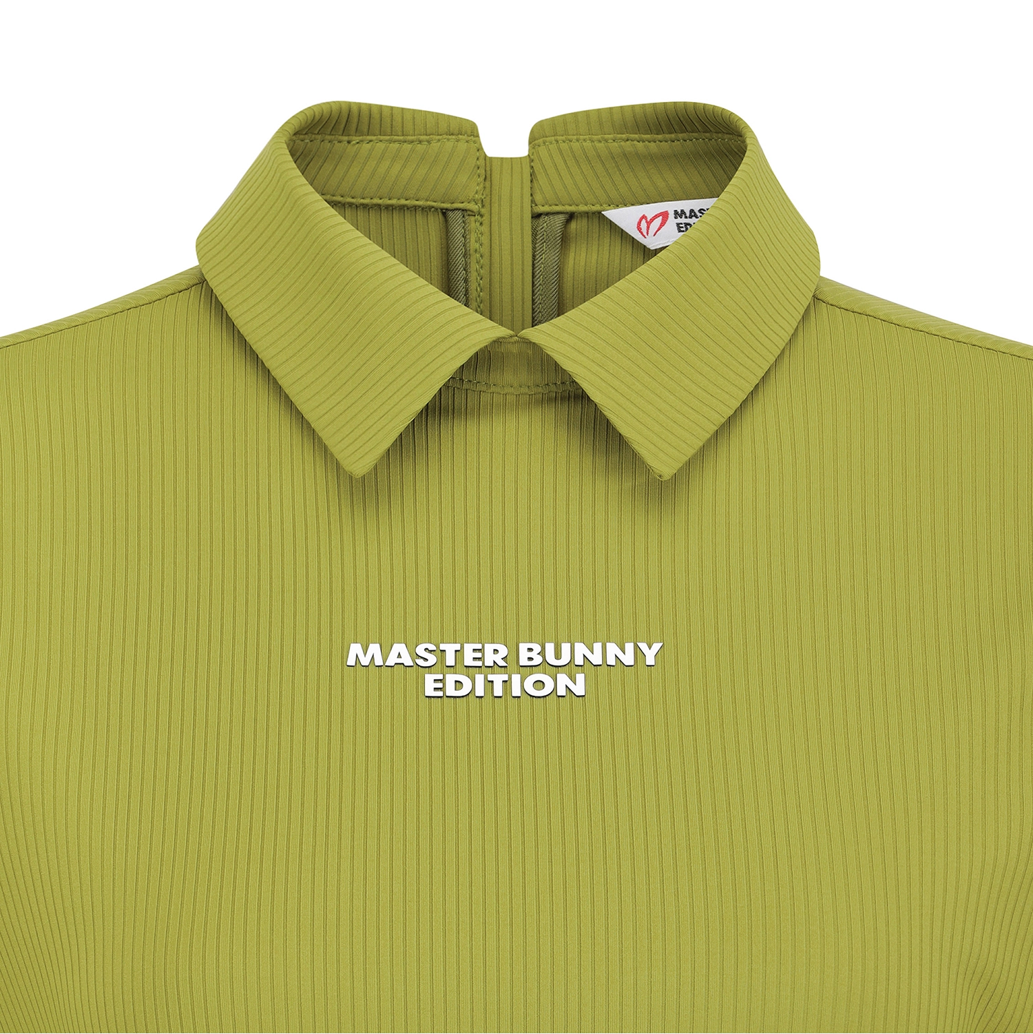Close-up of a collared ribbed knit top in a muted olive-lime green, with white text reading 'MASTER BUNNY EDITION' across the chest and a small visible neck label.
