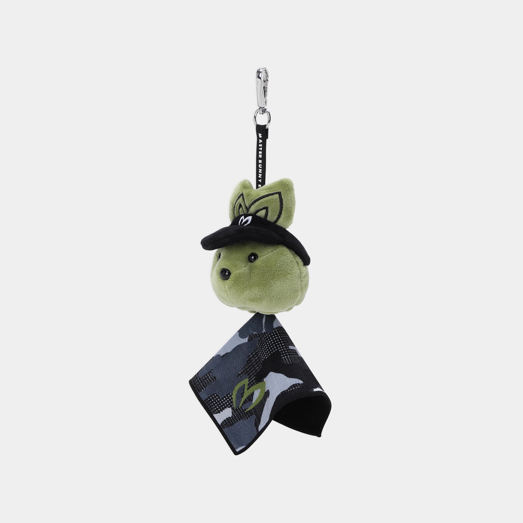 A plush keychain or bag charm featuring a green bunny head wearing a black visor, attached to a black strap with a silver clasp and a black-and-gray camouflage scarf.