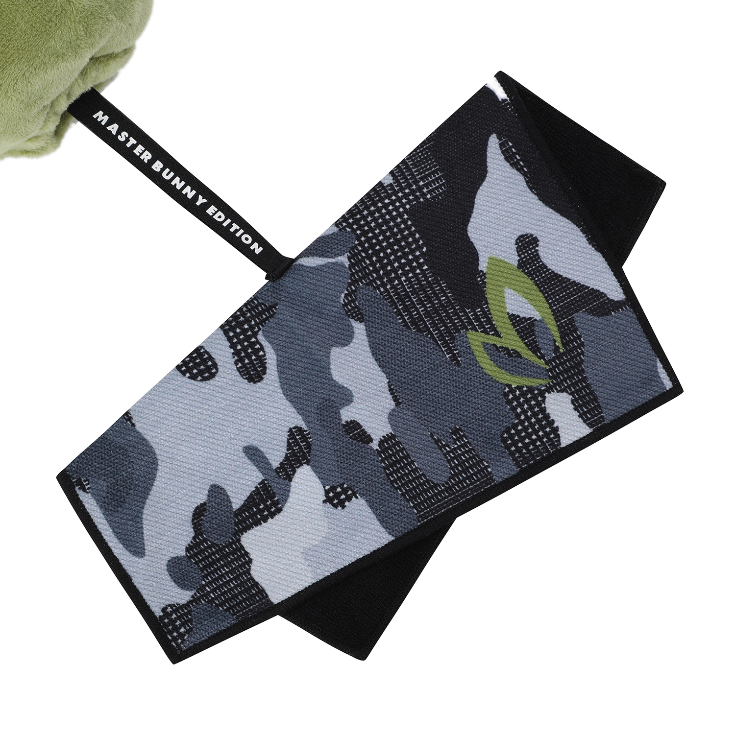 A camouflage-patterned towel with a black strap labeled 'MASTER BUNNY EDITION' and a green bunny logo, shown on a white background.