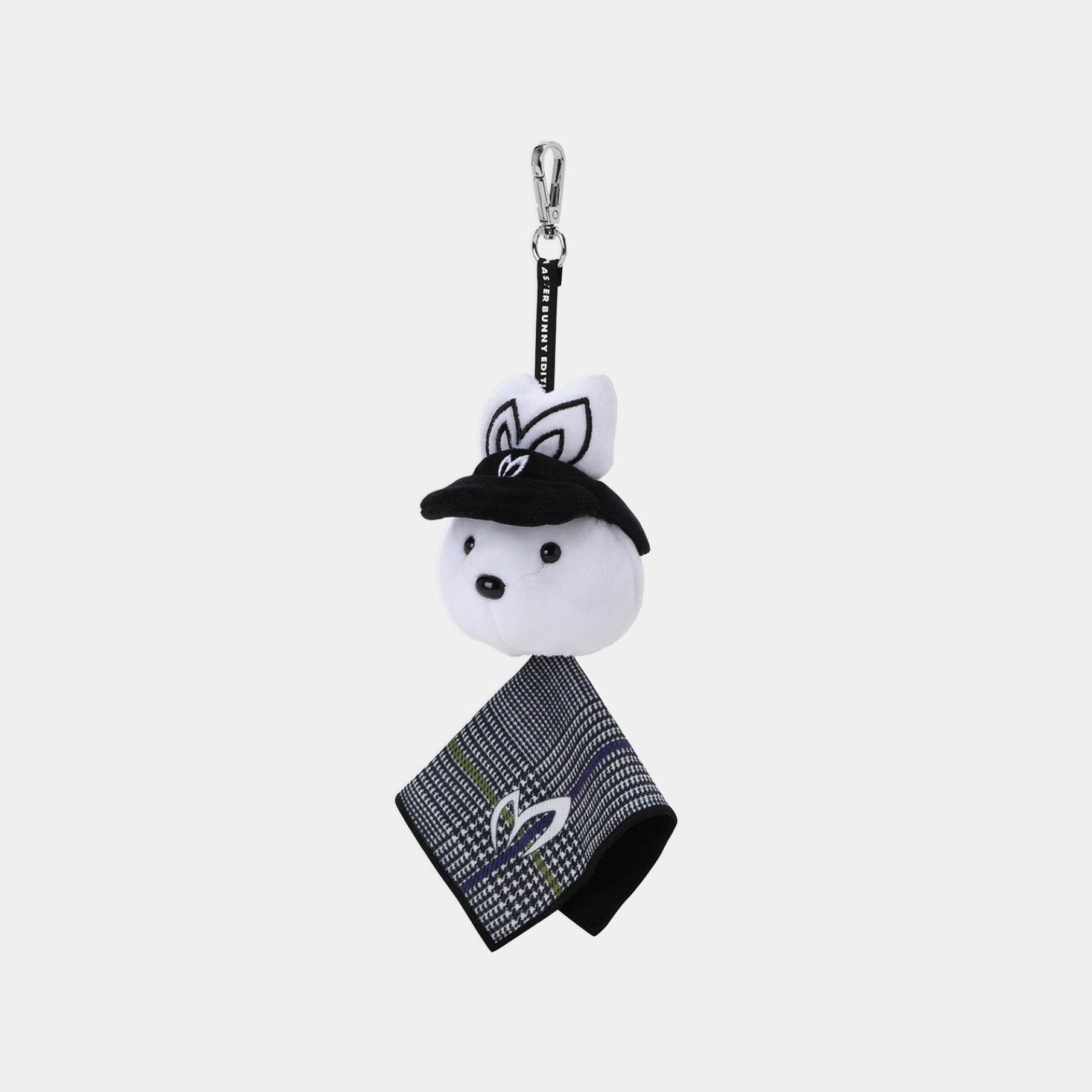 A small plush keychain or bag charm featuring a white rabbit head wearing a black hat, attached to a black strap with a silver clasp, and a black-and-white patterned fabric tag hangs below. The rabbit has embroidered black ears and facial details.