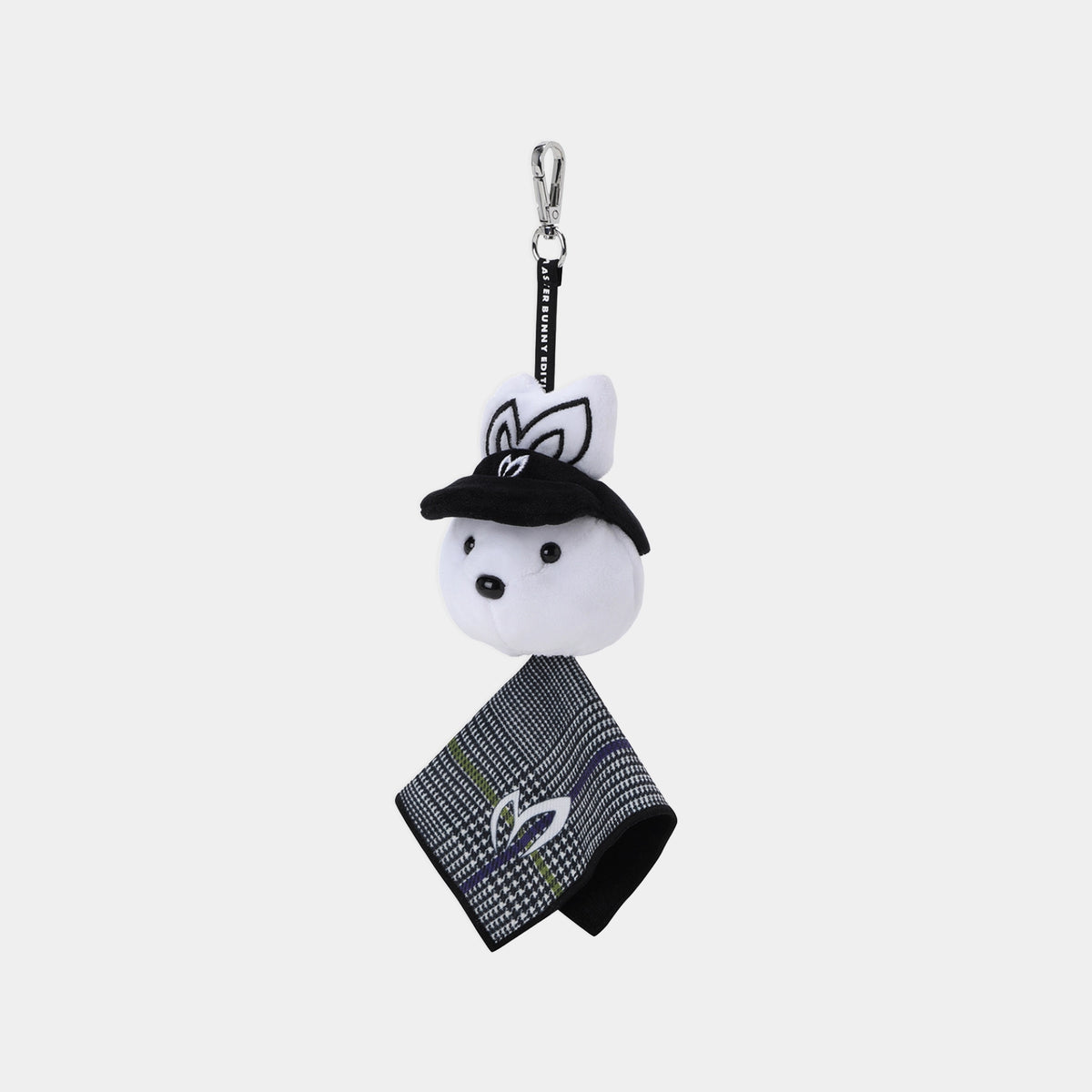 A small plush keychain or bag charm featuring a white rabbit head wearing a black hat, attached to a black strap with a silver clasp, and a black-and-white patterned fabric tag hangs below. The rabbit has embroidered black ears and facial details.