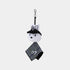 A small plush keychain or bag charm featuring a white rabbit head wearing a black hat, attached to a black strap with a silver clasp, and a black-and-white patterned fabric tag hangs below. The rabbit has embroidered black ears and facial details.