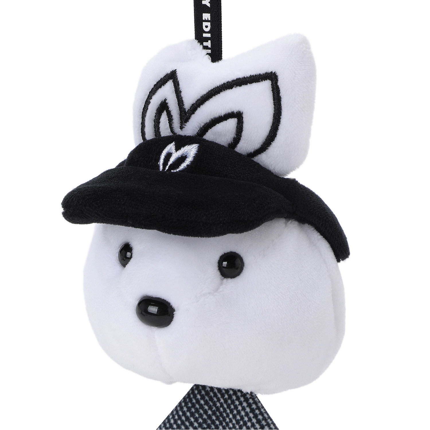 A white plush character accessory with black embroidered details, wearing a black cap and a black-and-white patterned necktie, shown on a plain white background.