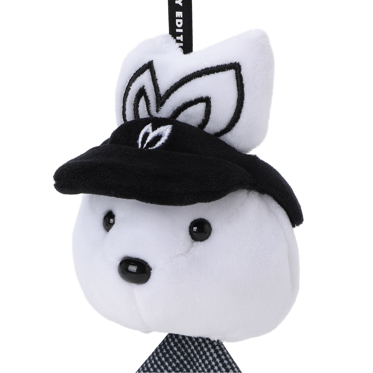 A white plush character accessory with black embroidered details, wearing a black cap and a black-and-white patterned necktie, shown on a plain white background.