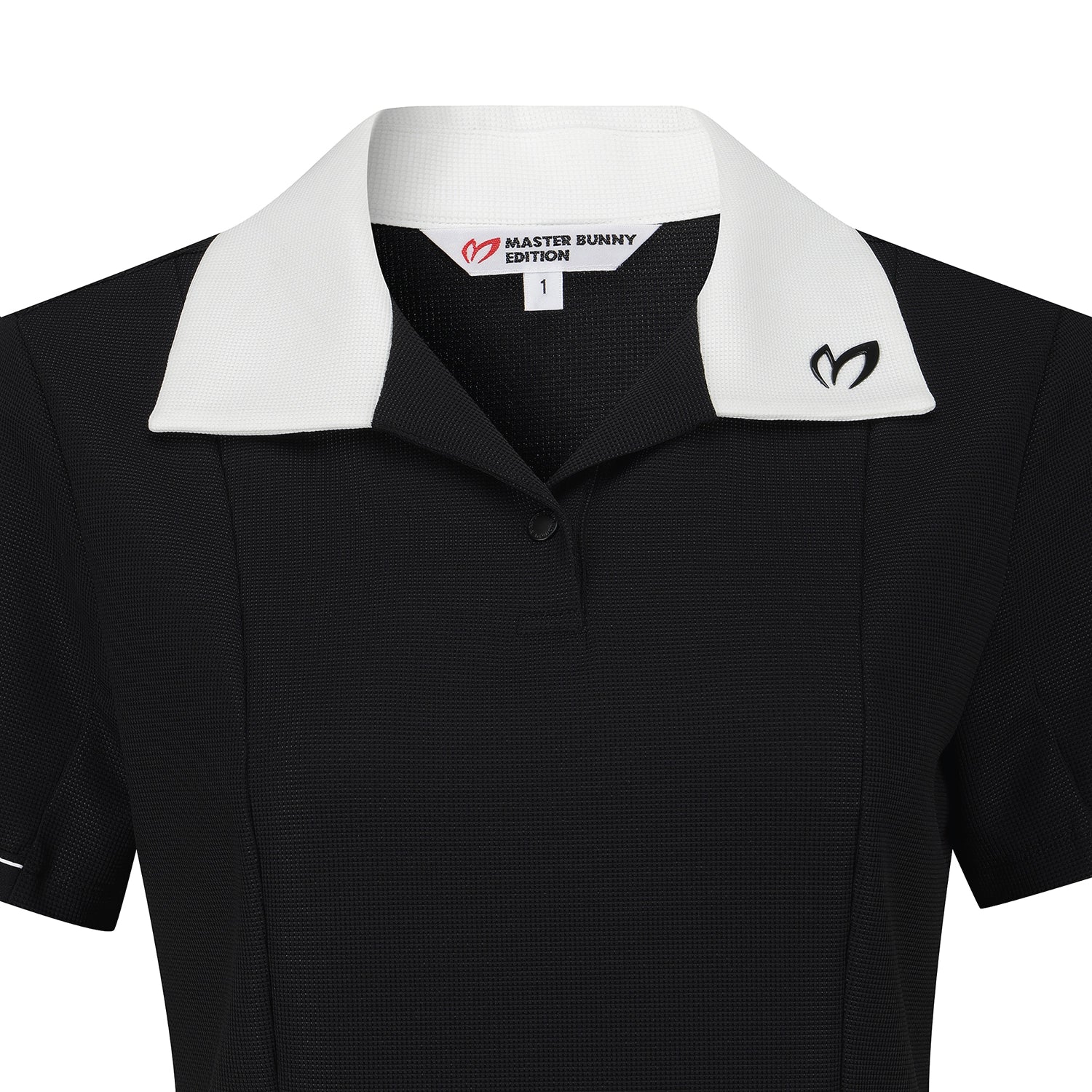 A close-up of a black short-sleeve polo shirt with a contrasting white collar. The inner neck label reads 'MASTER BUNNY EDITION' with a red logo, and a black Master Bunny logo is embroidered on the left chest.