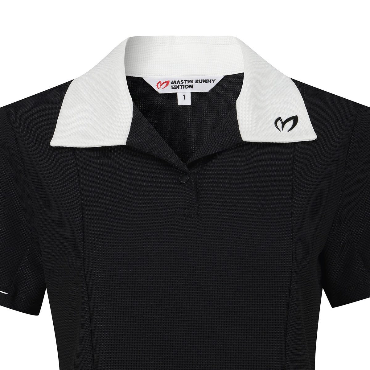 A close-up of a black short-sleeve polo shirt with a contrasting white collar. The inner neck label reads 'MASTER BUNNY EDITION' with a red logo, and a black Master Bunny logo is embroidered on the left chest.