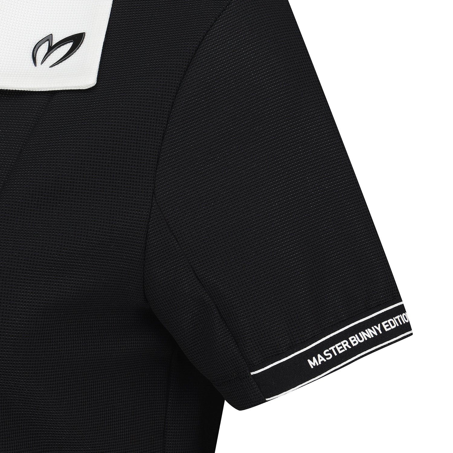Close-up of a black short-sleeve athletic jersey with a white shoulder yoke, a black abstract logo on the shoulder, and white text reading 'MASTER BUNNY EDITION' on the sleeve cuff.