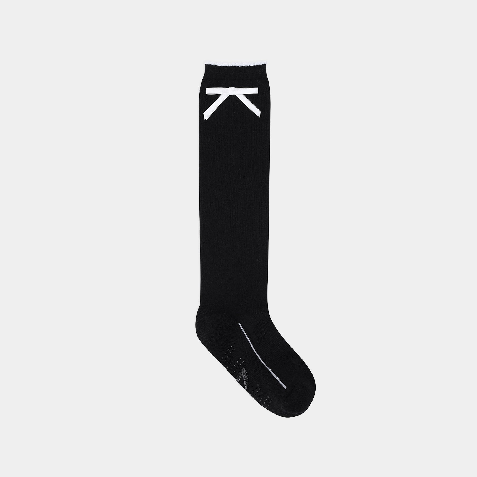 A single black crew sock with a white stylized 'X' logo near the cuff and a white line detail on the toe, shown against a light gray background.