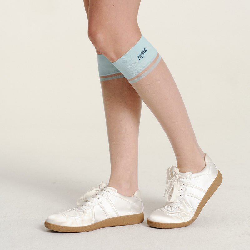 Keypote Women's Knee High Sock Blue - worn on model, compression knee-high golf sock lifestyle shot | Erthe Golf