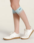 Keypote Women's Knee High Sock Blue - worn on model, compression knee-high golf sock lifestyle shot | Erthe Golf