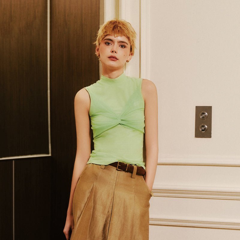 Keypote Women's mint green knot mockneck sleeveless golf top, model wearing with wide-leg trousers