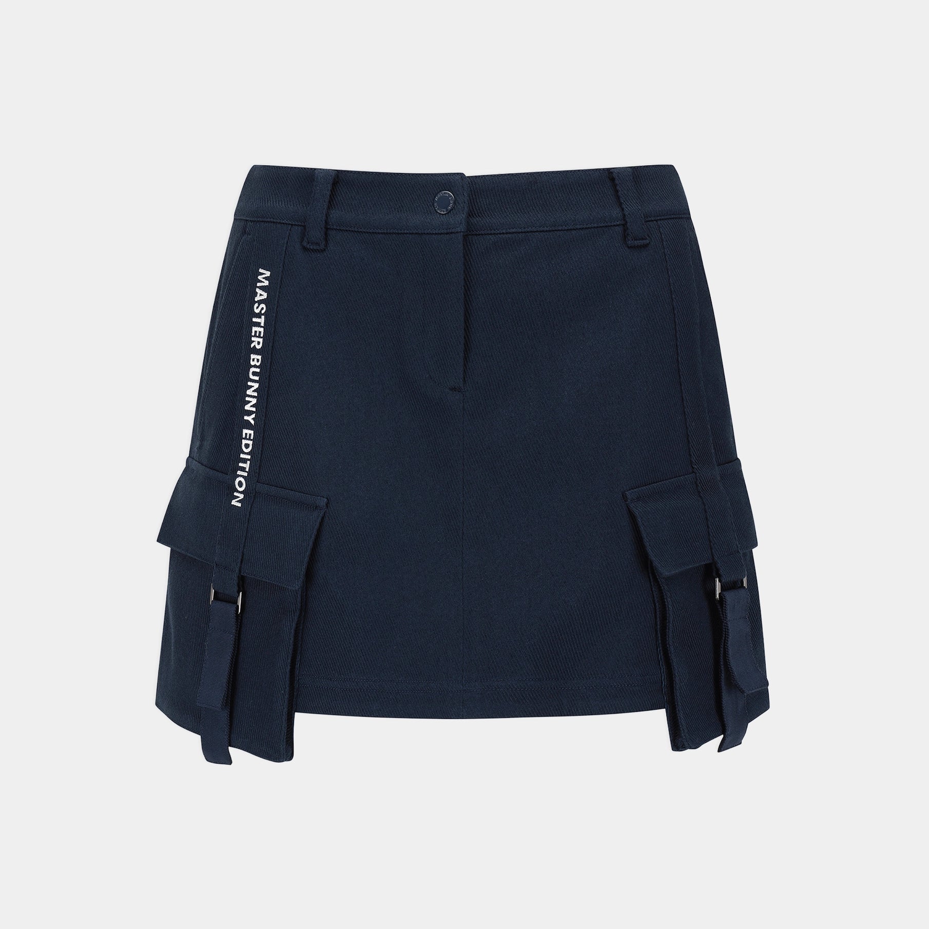 A navy blue mini skirt with side cargo pockets and white vertical text reading 'MASTER BUNNY EDITION' on the left side, shown against a light gray background.