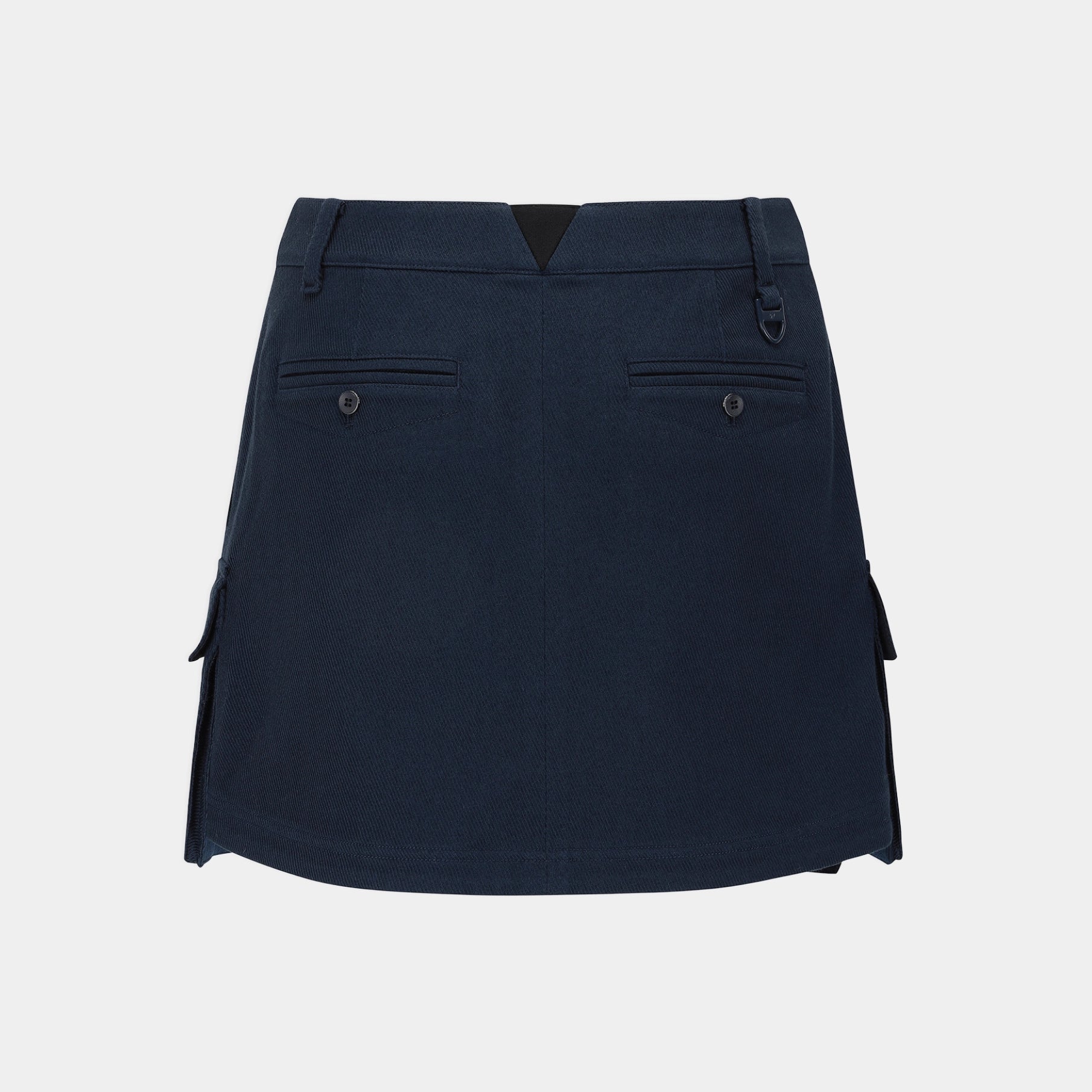 A dark navy blue A-line mini skirt with side cargo pockets and flap details, shown from the back against a light gray background.