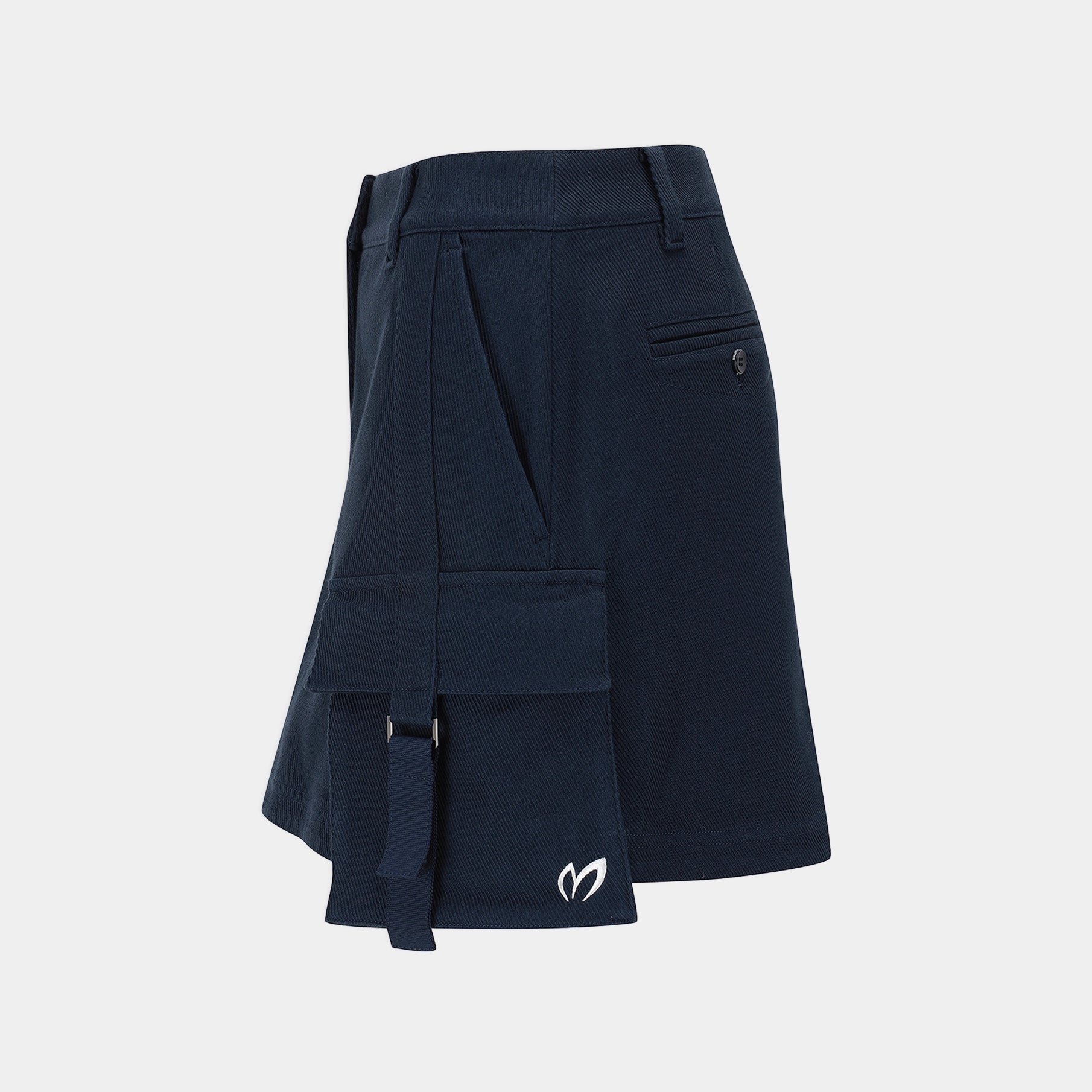 A dark navy blue asymmetrical skirt with multiple cargo-style pockets, belt loops, and a small white embroidered logo near the hem, shown on a light gray background.