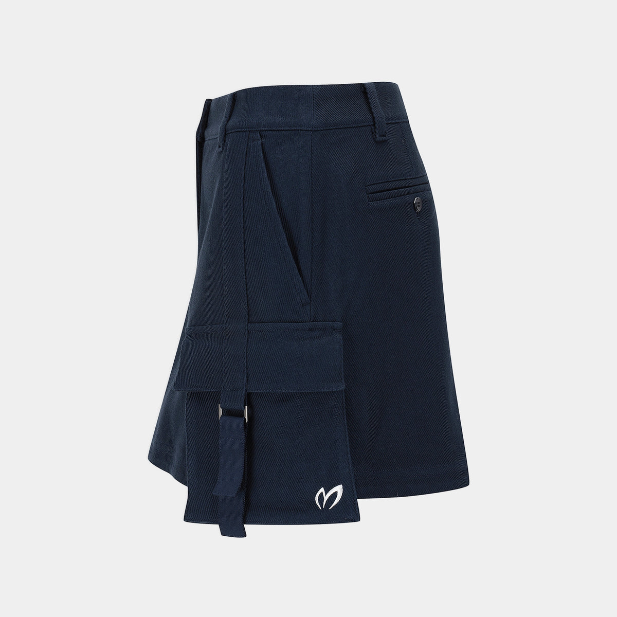 A dark navy blue asymmetrical skirt with multiple cargo-style pockets, belt loops, and a small white embroidered logo near the hem, shown on a light gray background.