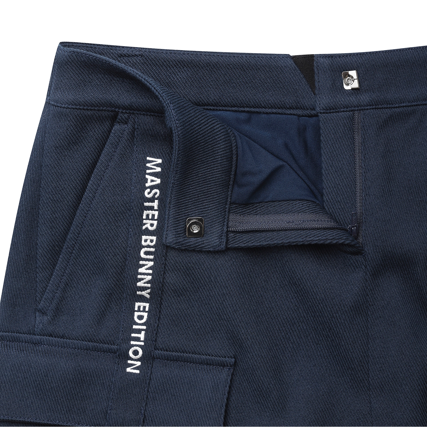 Close-up of navy blue pants showing the waistband, pocket, and white vertical text reading 'MASTER BUNNY EDITION' on the side.