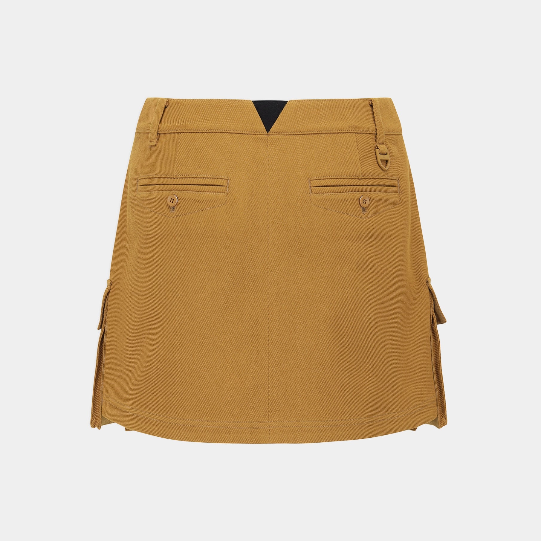 A mustard yellow utility mini skirt shown from the back, featuring two buttoned flap pockets, belt loops, and side cargo pockets, set against a plain light gray background.