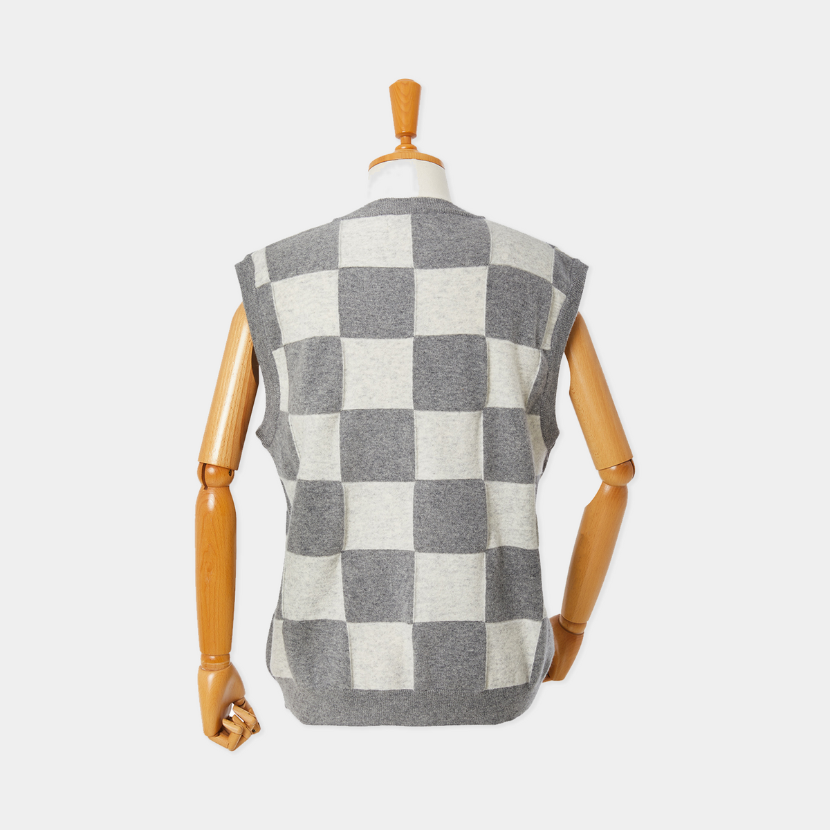 Checkered vest on a mannequin against a white background