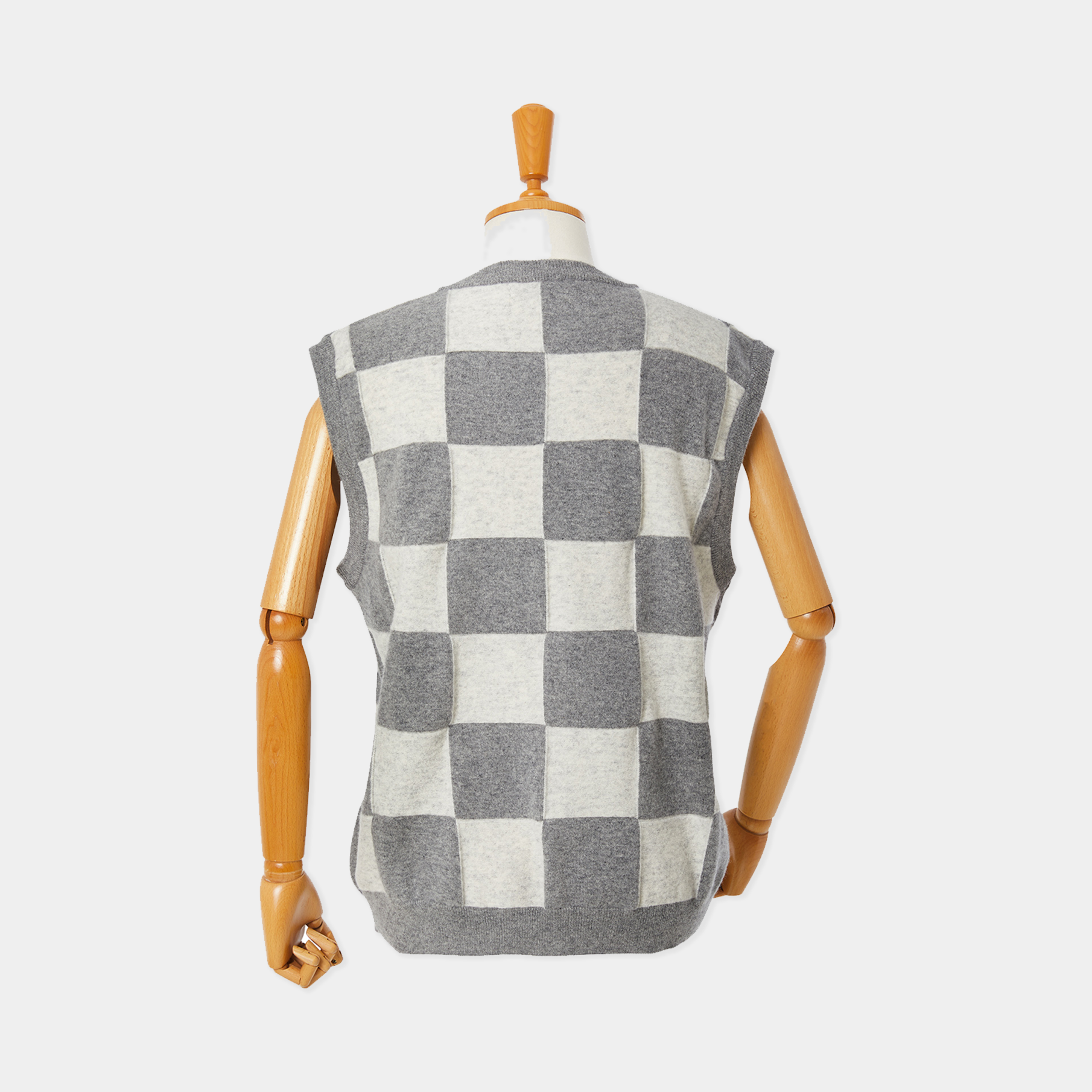 Checkered vest on a mannequin against a white background