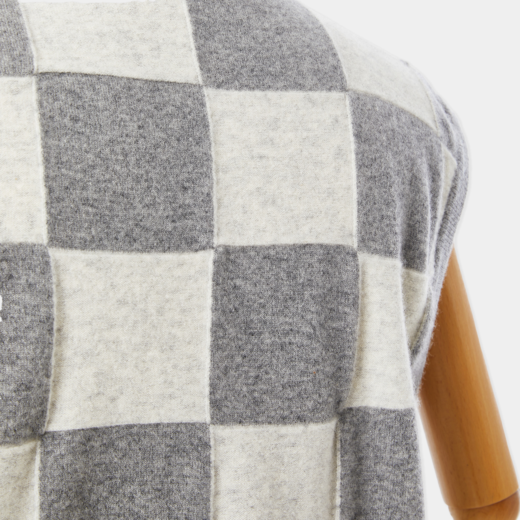 Close-up of a checkered fabric with gray and white squares on a white background