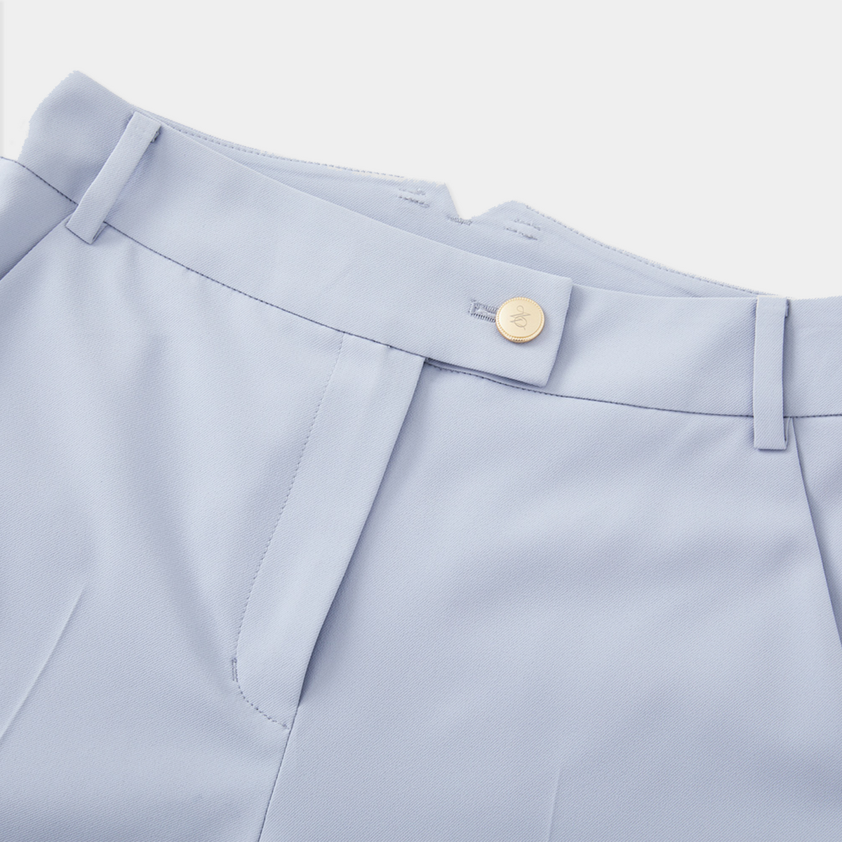Light blue pants with a button on a white background