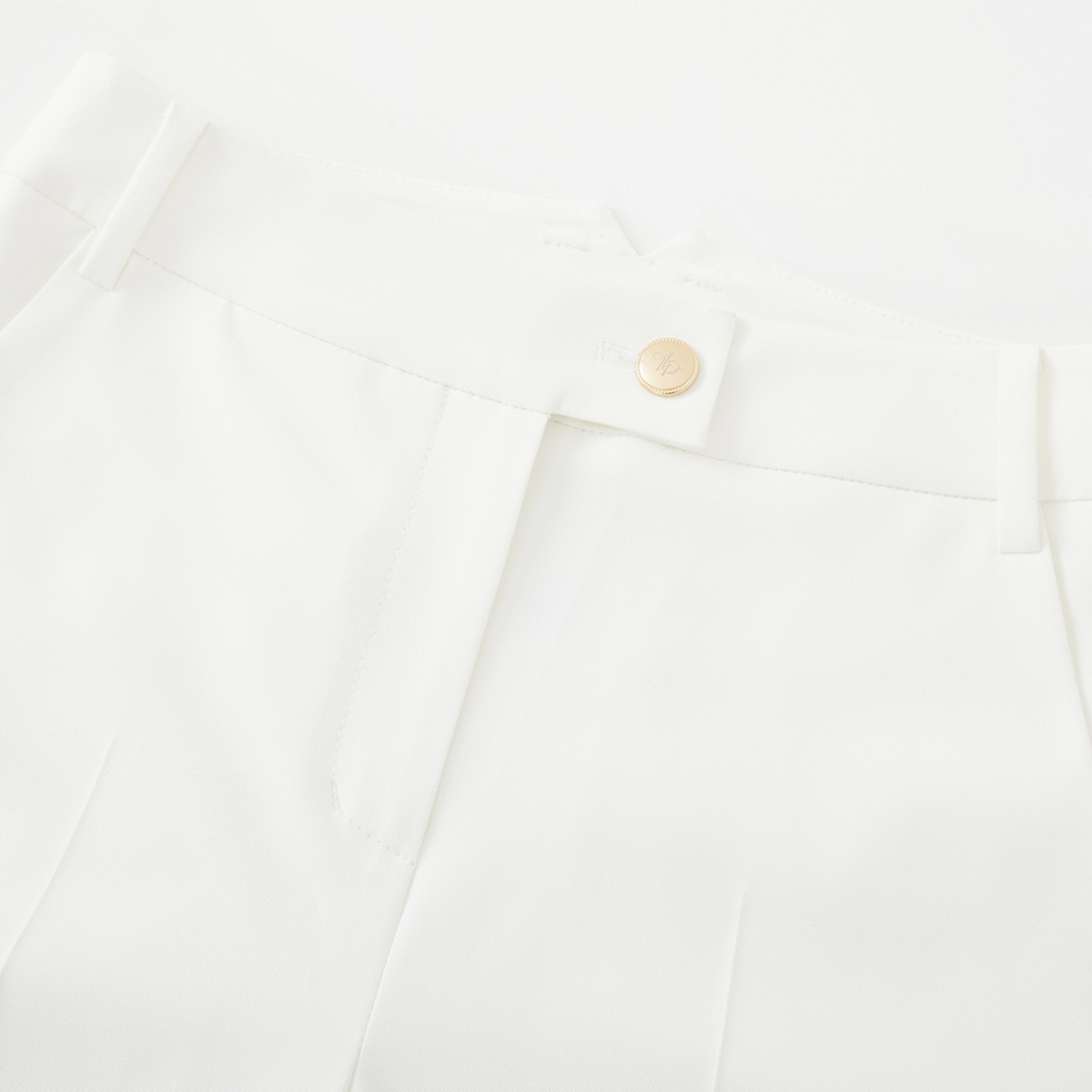Close-up of a white short pocket with a button on a white background