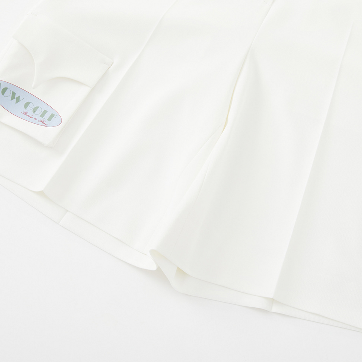Close-up of a white fabric with a brand label in the corner.