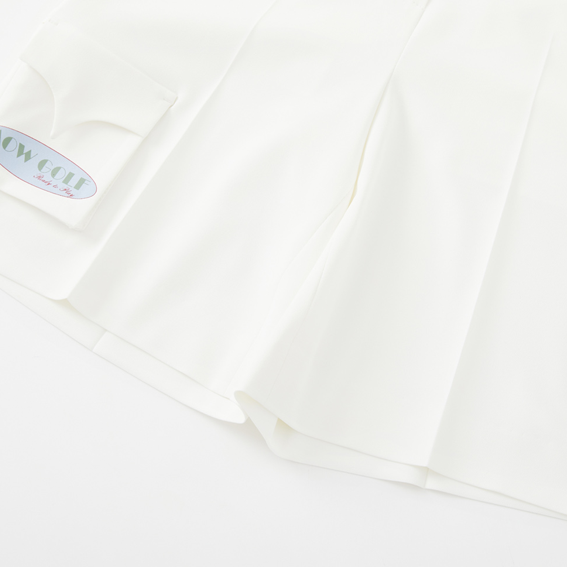 Close-up of a white fabric with a brand label in the corner.